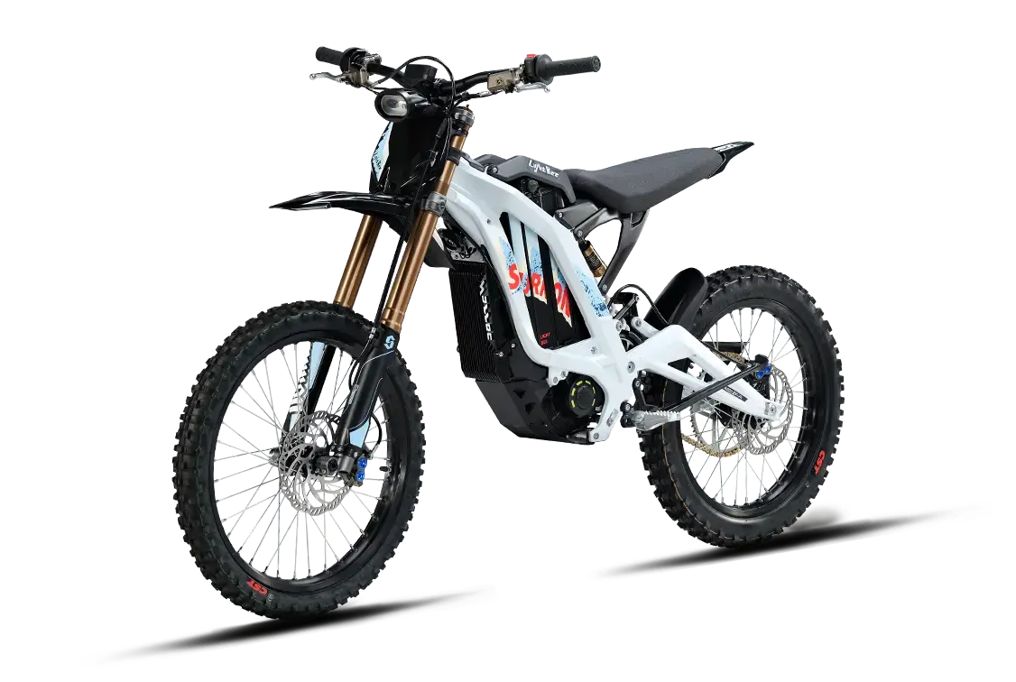 Silver, white, and blue edition 2026 Sur-Ron Light Bee X electric dirt bike three-quarters front view highlighting the 72V battery pack and forged frame.