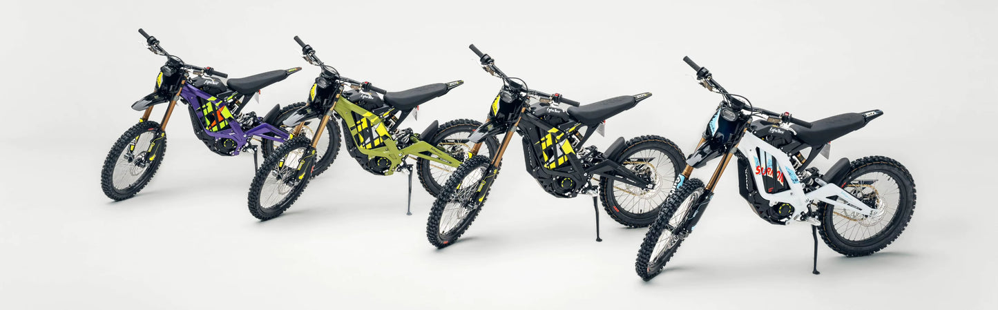Full lineup of 2026 Sur-Ron Light Bee X (72V 10kW) electric dirt bikes showcased in purple, green, black-yellow, and white graphic colorways.
