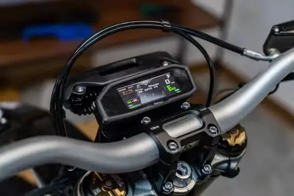 2026 Sur-Ron Light Bee LBX2 digital LCD speedometer dash display and handlebar control cockpit close-up.