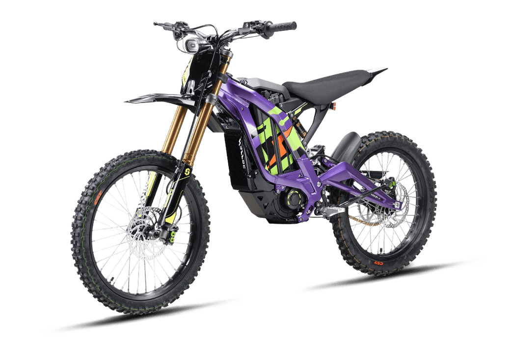 Purple and neon graphic edition 2026 Sur-Ron Light Bee X electric dirt bike three-quarters view showcasing 72V architecture, gold inverted front forks, and off-road spoked wheels.