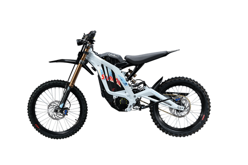 Side profile of white and silver 2026 Sur-Ron Light Bee X (72V 10kW) electric dirt bike highlighting mid-drive PMSM motor, lightweight aluminum frame, and rear chain drive.