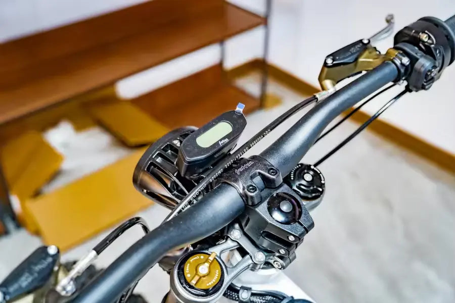 2026 Sur-Ron Light Bee X handlebar cockpit with digital speedometer LCD display and suspension controls.