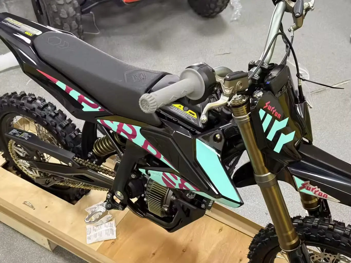 2026 Sur-Ron Hyper Bee front 3/4 close-up view showing gold inverted forks, mid-motor, and custom graphics.